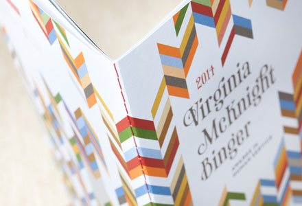 Image of a brochure for the Virginia McKnight Binger Awards in Human Service. Brochure has a stitched spine with red thread.